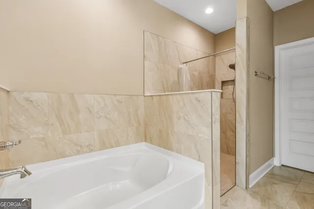 a bathroom with a bathtub and shower