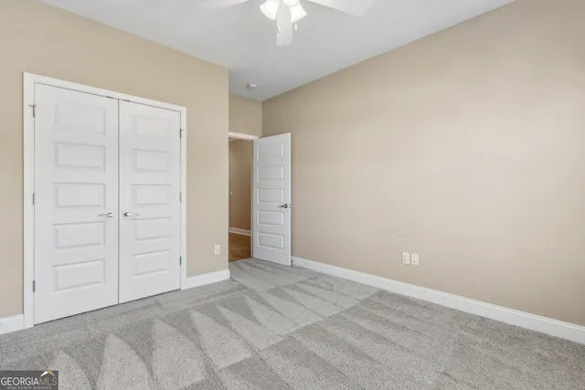 an empty room with a ceiling fan