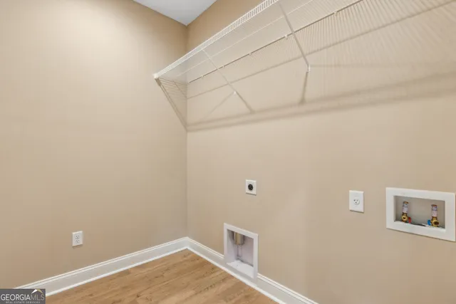 a view of a room with wooden floor and white walls