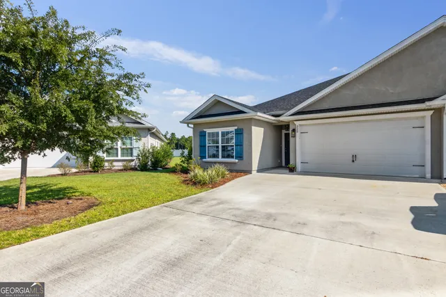 a front view of house with yard and green space