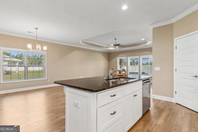 a kitchen with a stove and a wooden floor