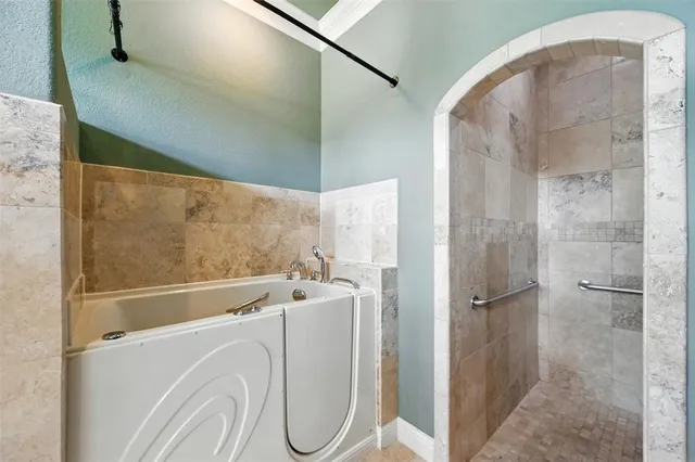 a bathroom with a granite countertop shower and a sink