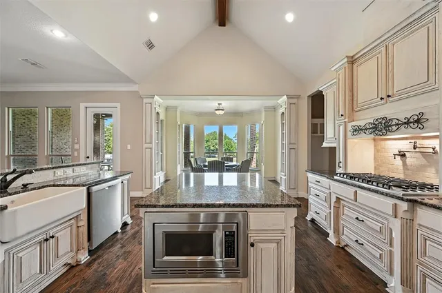 a kitchen with stainless steel appliances granite countertop a stove and a sink
