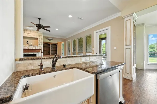 a bathroom with a granite countertop sink and bathtub
