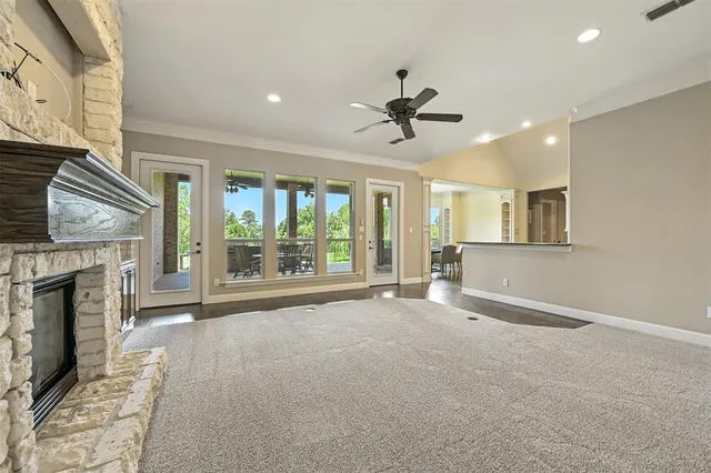 a view of an empty room with a fireplace and a window