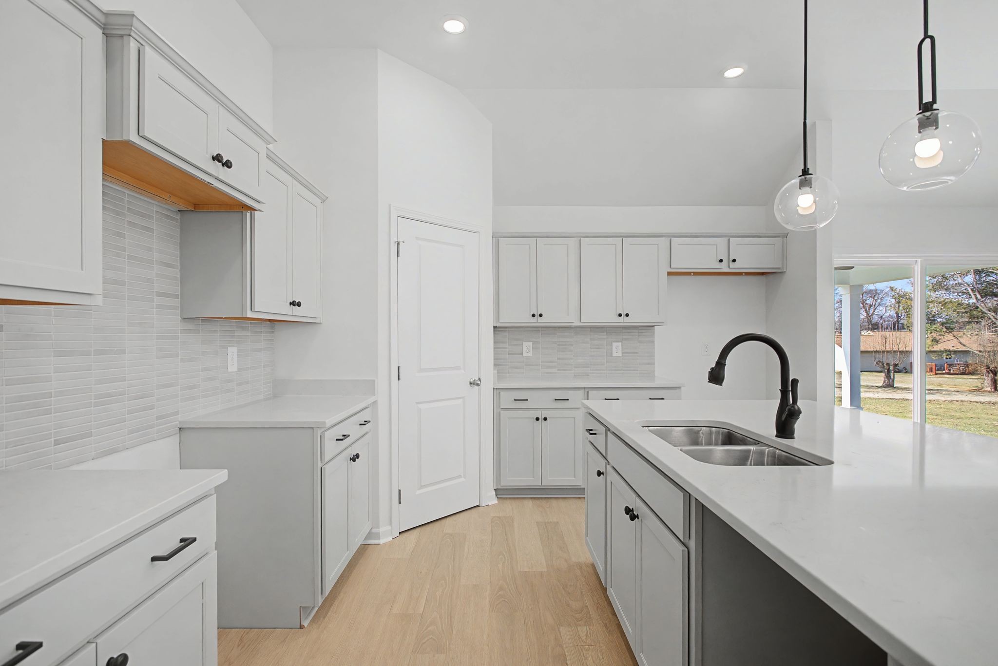 614 Brookside Drive Mount Pleasant, TN 38474 - Photo 19 of 41 a kitchen with white cabinets a sink dishwasher and a stove with wooden floor