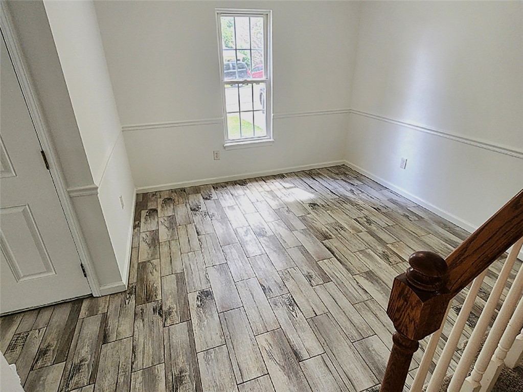 328 Springfield Circle Easley, SC 29642 - Photo 15 of 29 Sun-filled room boasts resilient tile flooring, mimicking wood grain for enduring charm.