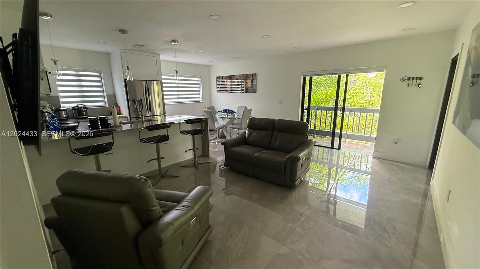 13675 Southwest 62nd Street, Unit 2023 Miami, FL 33183 - Photo 6 of 22 a living room with furniture and a window