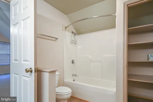 a bathroom with a shower a bathtub and a shower
