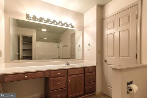 a bathroom with a double vanity sink and mirror