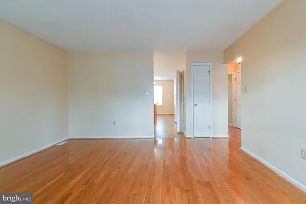 a view of a room with wooden floor