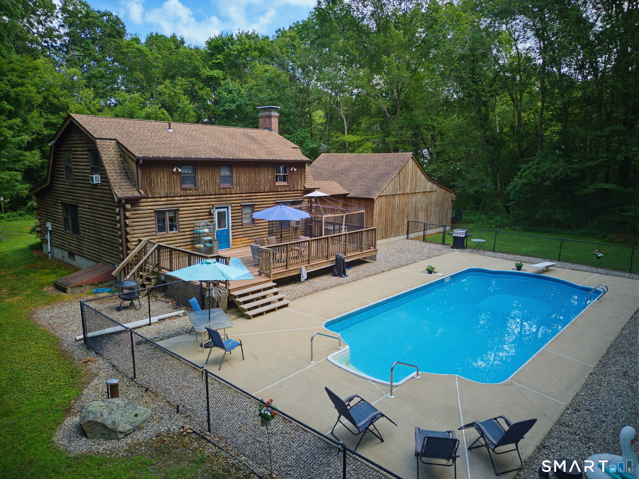 151 Fire Tower Road Eastford, CT 06242 - Photo 30 of 39 The back yard is a game changer! Pool, Patio, Deck and yard that is bordered by trees, which provide a natural privacy buffer.