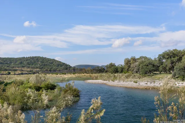 a view of a lake with houses in the back
