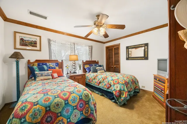 a bedroom with two beds and a chandelier