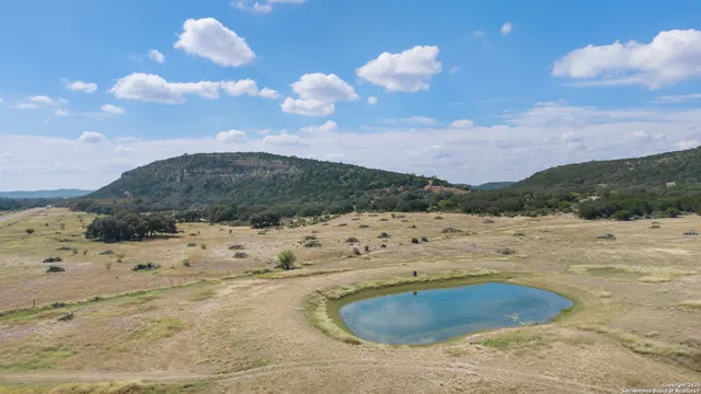 a view of a dry yard with wooden fence