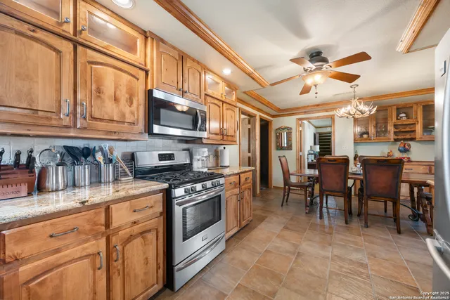 a kitchen with stainless steel appliances granite countertop a stove and cabinets