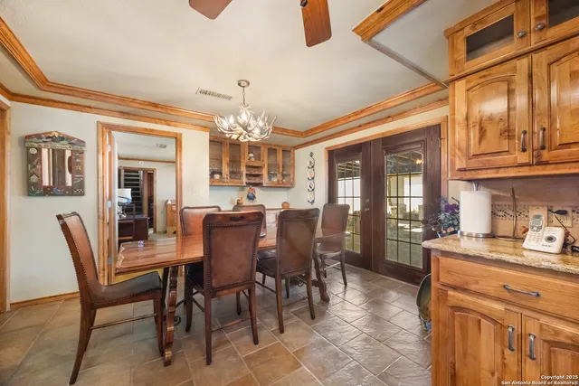 a dining room with furniture a chandelier and window
