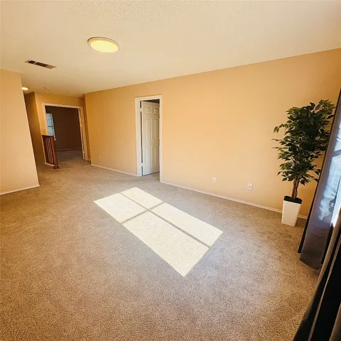 a view of an empty room and a window