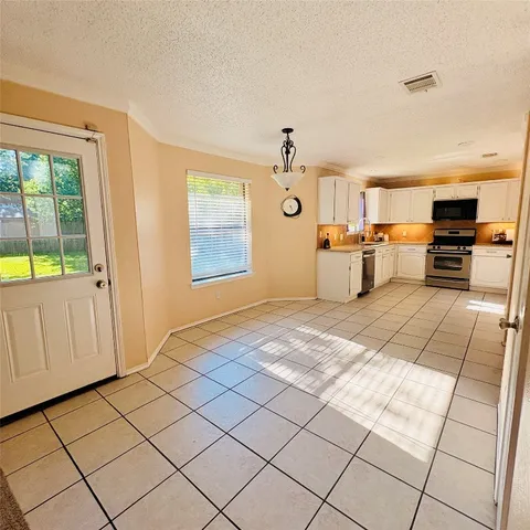 a view of a livingroom with furniture and a window