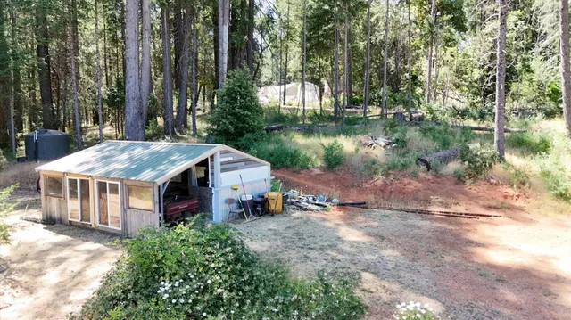 a front view of a house with a yard garage and outdoor seating