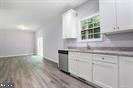 Plum Tree Lane Berkeley Springs, WV 25411 - Photo 5 of 18 a kitchen with granite countertop white cabinets and window