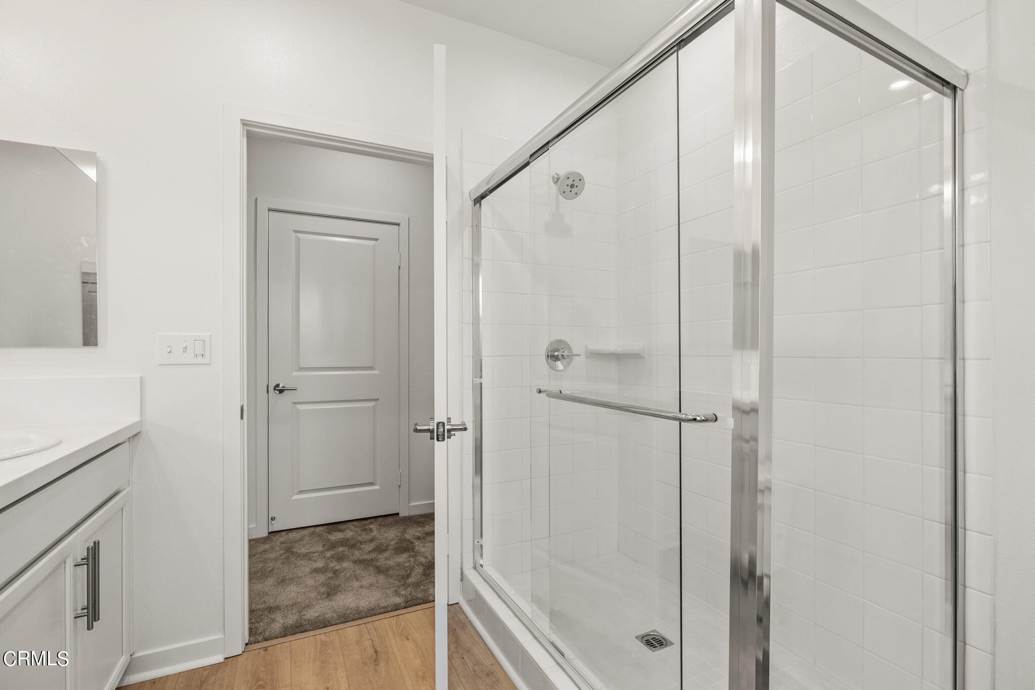 311 North F Street, Unit 202 Oxnard, CA 93030 - Photo 17 of 32 a bathroom with a shower and a glass door