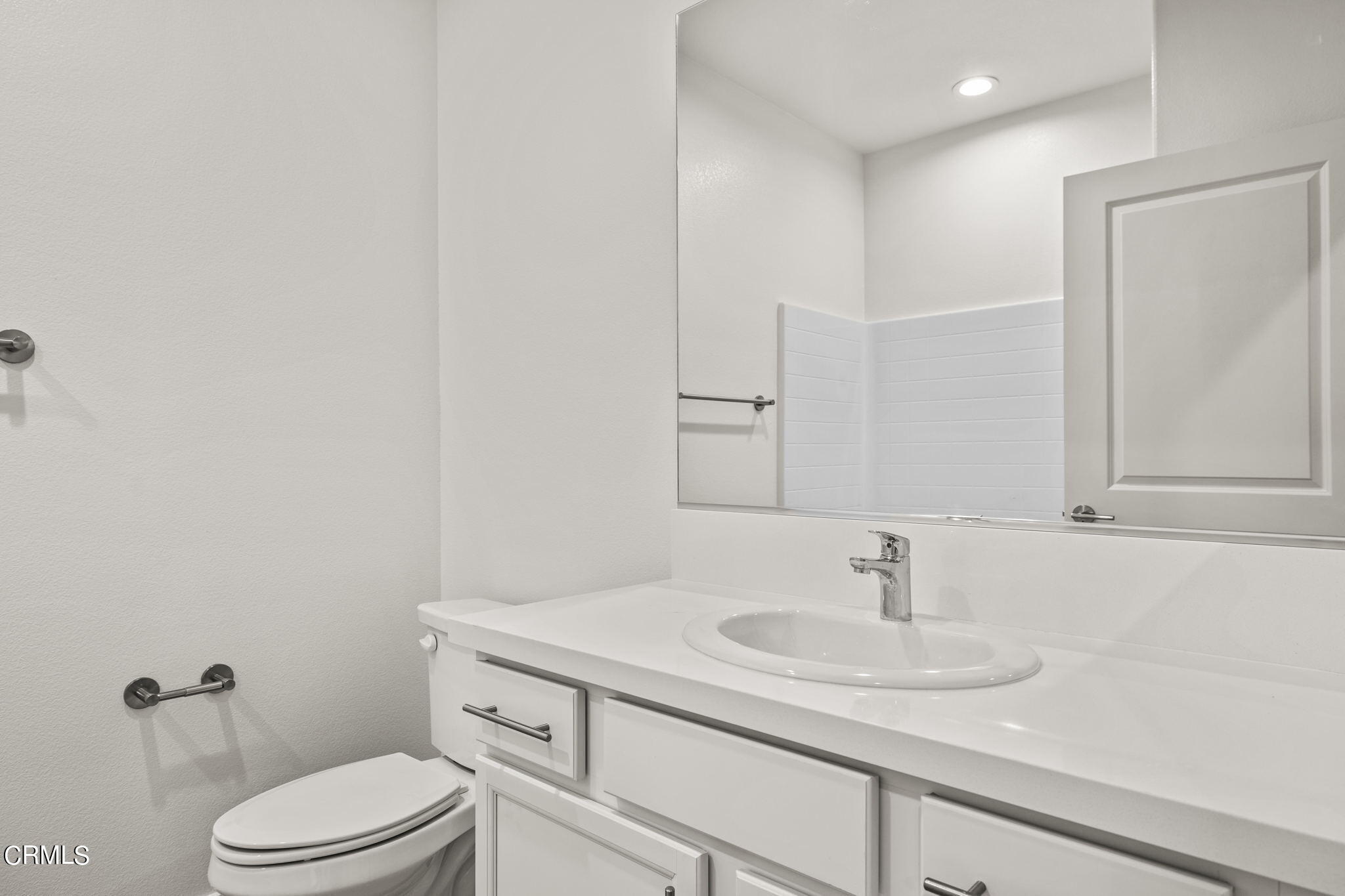 311 North F Street, Unit 202 Oxnard, CA 93030 - Photo 21 of 32 a bathroom with a sink toilet and vanity