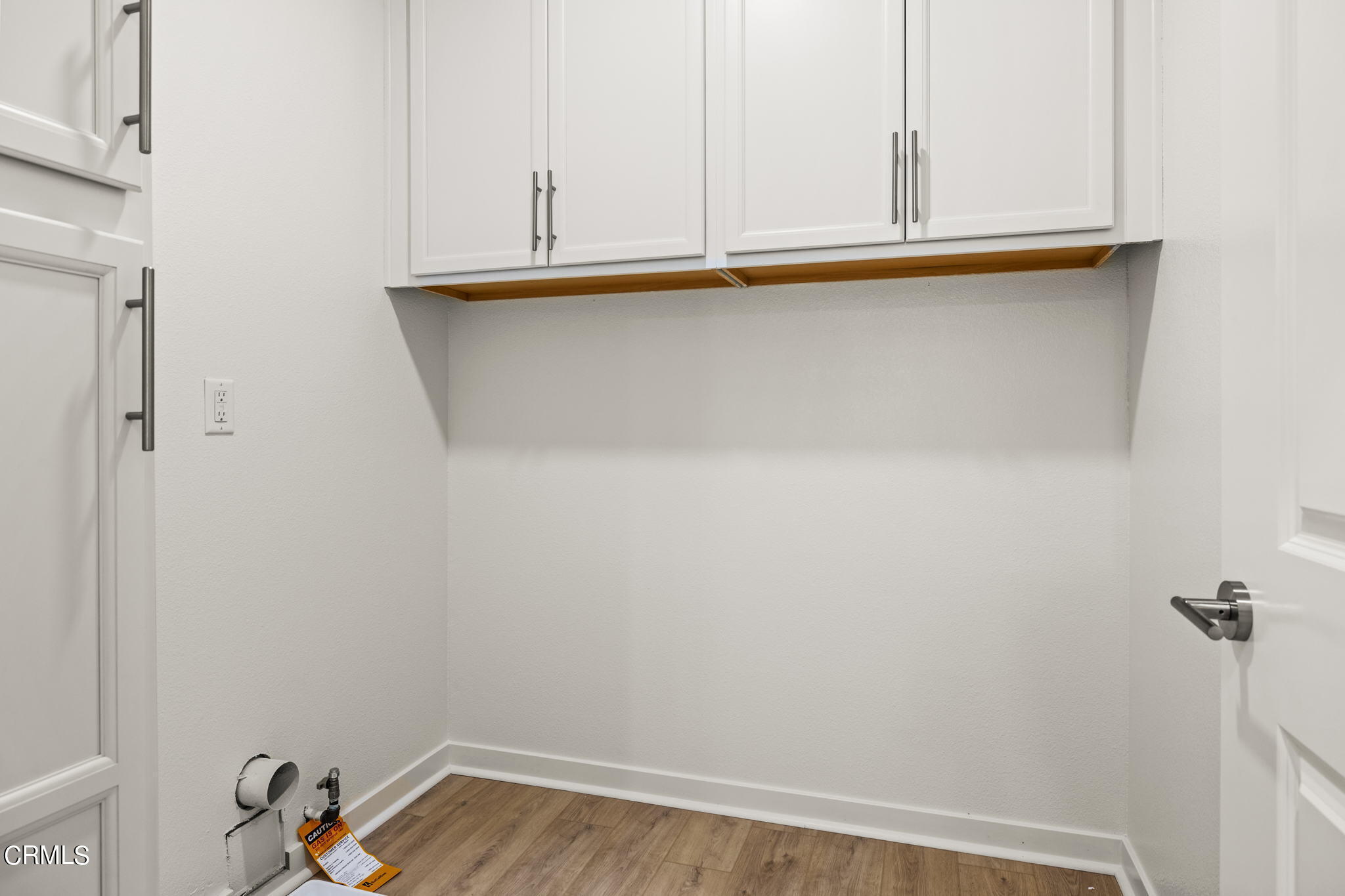 311 North F Street, Unit 202 Oxnard, CA 93030 - Photo 26 of 32 a view of storage and utility room with wooden floor