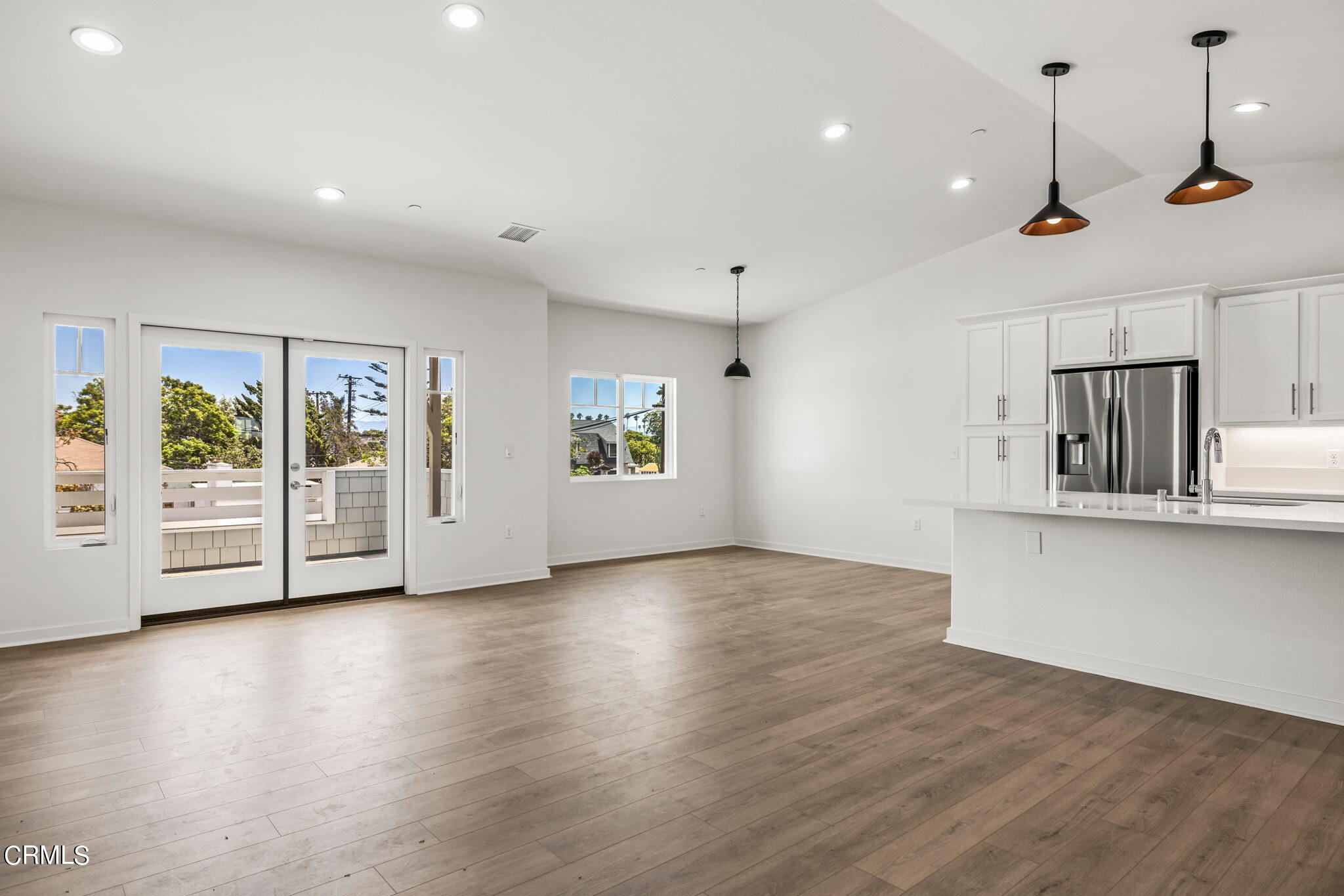 311 North F Street, Unit 202 Oxnard, CA 93030 - Photo 5 of 32 a view of an empty room with a window and wooden floor