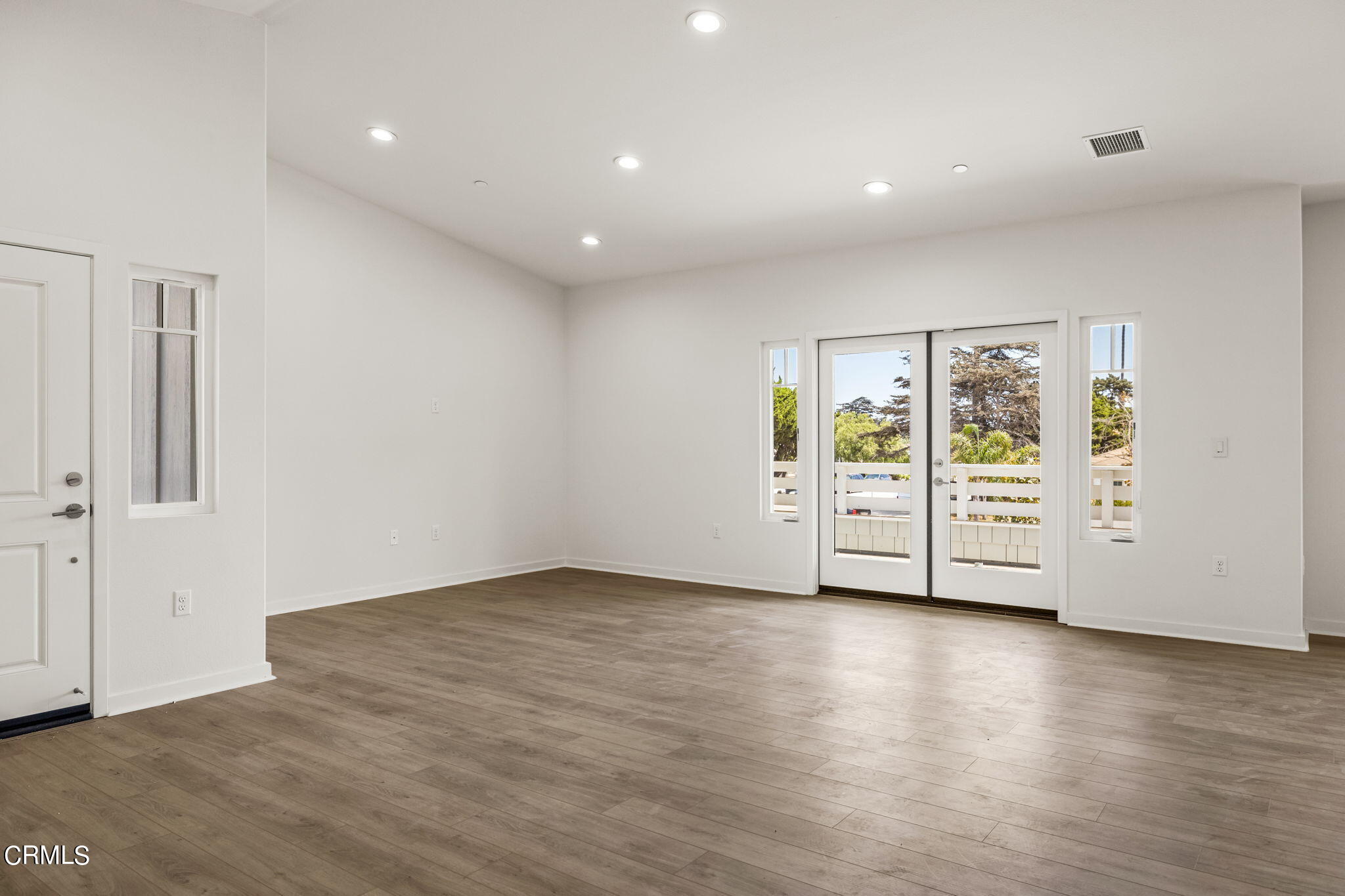 311 North F Street, Unit 202 Oxnard, CA 93030 - Photo 6 of 32 a view of an empty room with wooden floor and closet