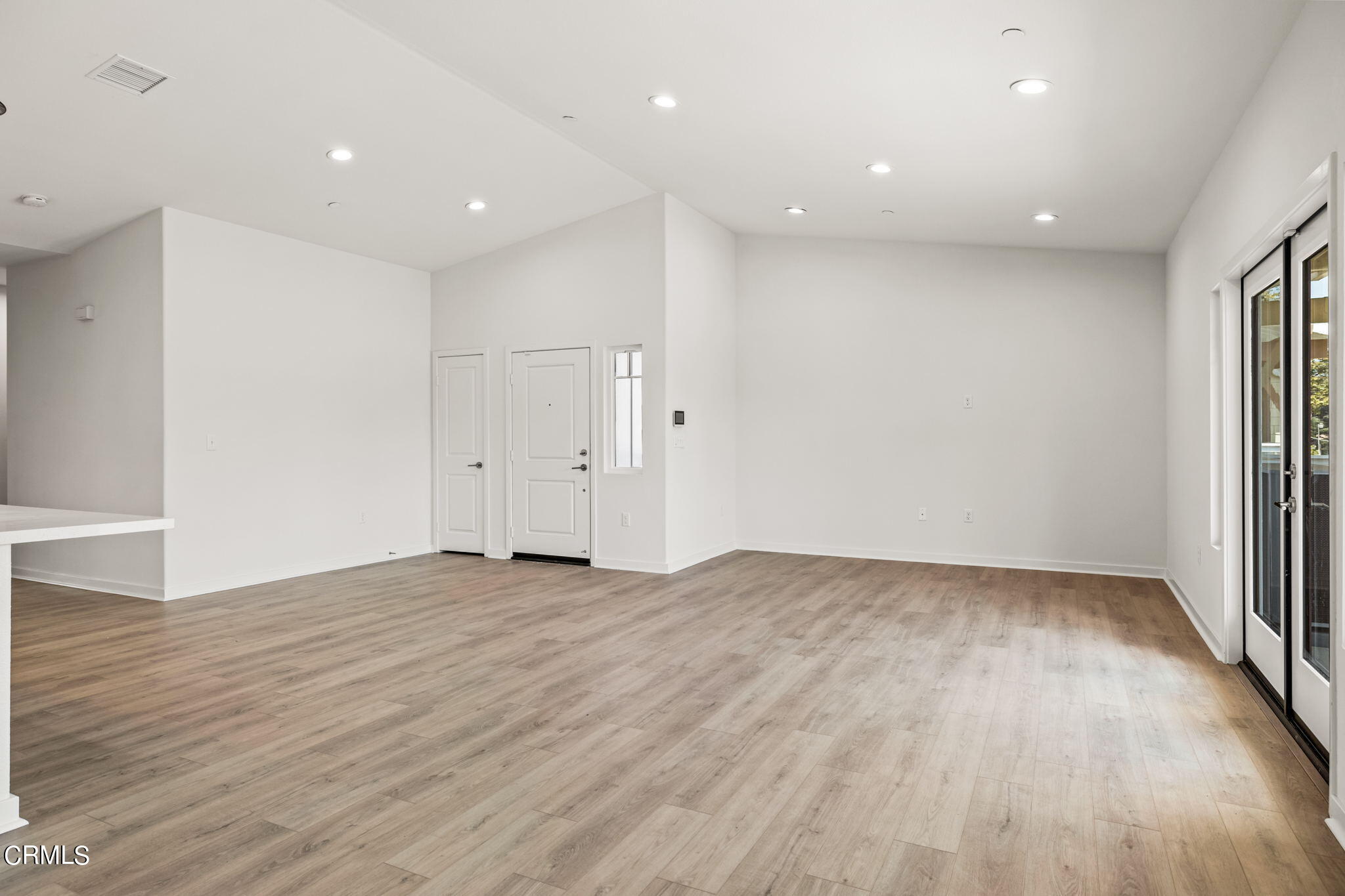 311 North F Street, Unit 202 Oxnard, CA 93030 - Photo 7 of 32 a view of an empty room with wooden floor