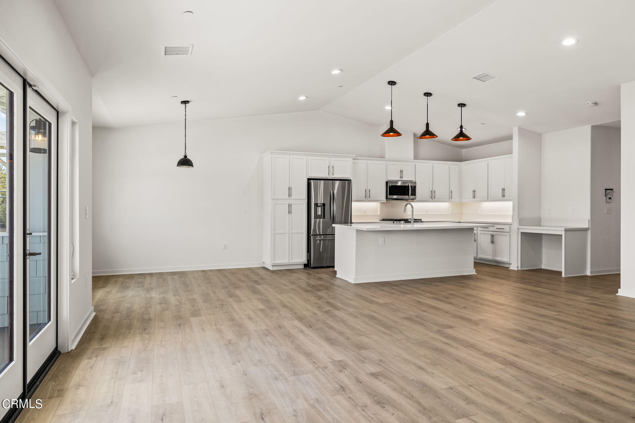 311 North F Street, Unit 202 Oxnard, CA 93030 - Photo 8 of 32 a view of kitchen with wooden floor and electronic appliances