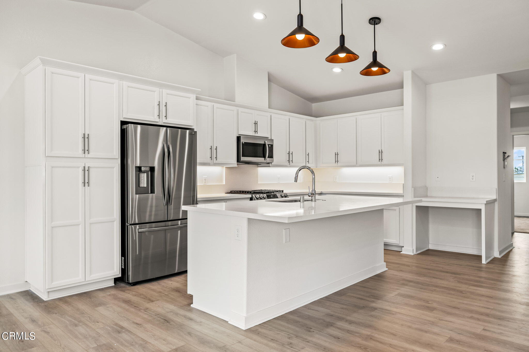 311 North F Street, Unit 202 Oxnard, CA 93030 - Photo 9 of 32 a kitchen with stainless steel appliances a refrigerator and a stove top oven