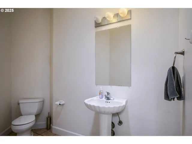 a bathroom with a sink toilet and mirror