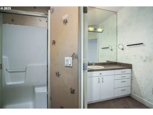 a bathroom with a granite countertop sink a toilet and a mirror
