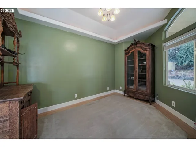 a view of an empty room with a fireplace and a window