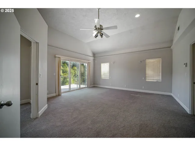 a view of a livingroom with a ceiling fan and window
