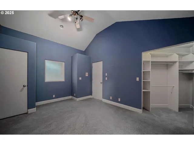 a view of an empty room with a ceiling fan