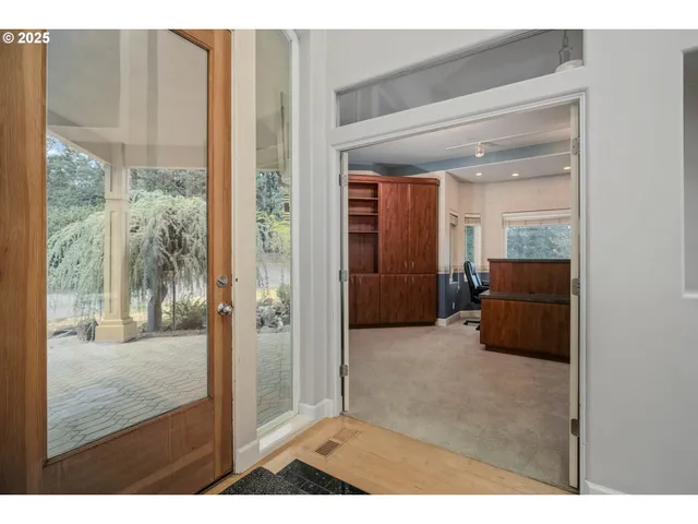 a living room with furniture and a refrigerator