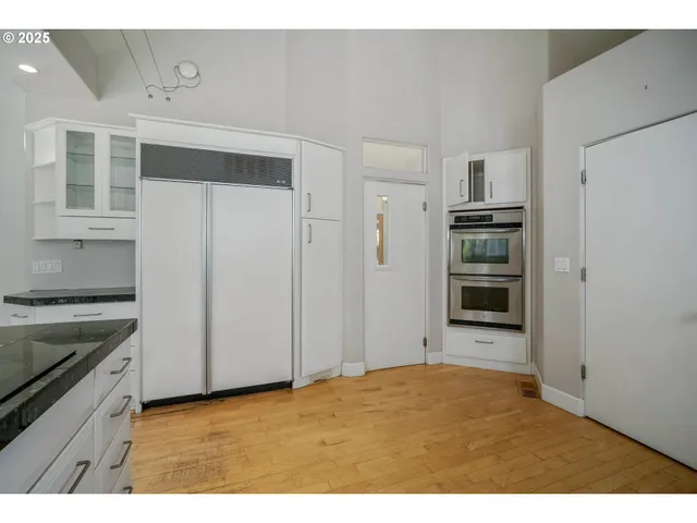 a kitchen with stainless steel appliances a refrigerator and a stove top oven