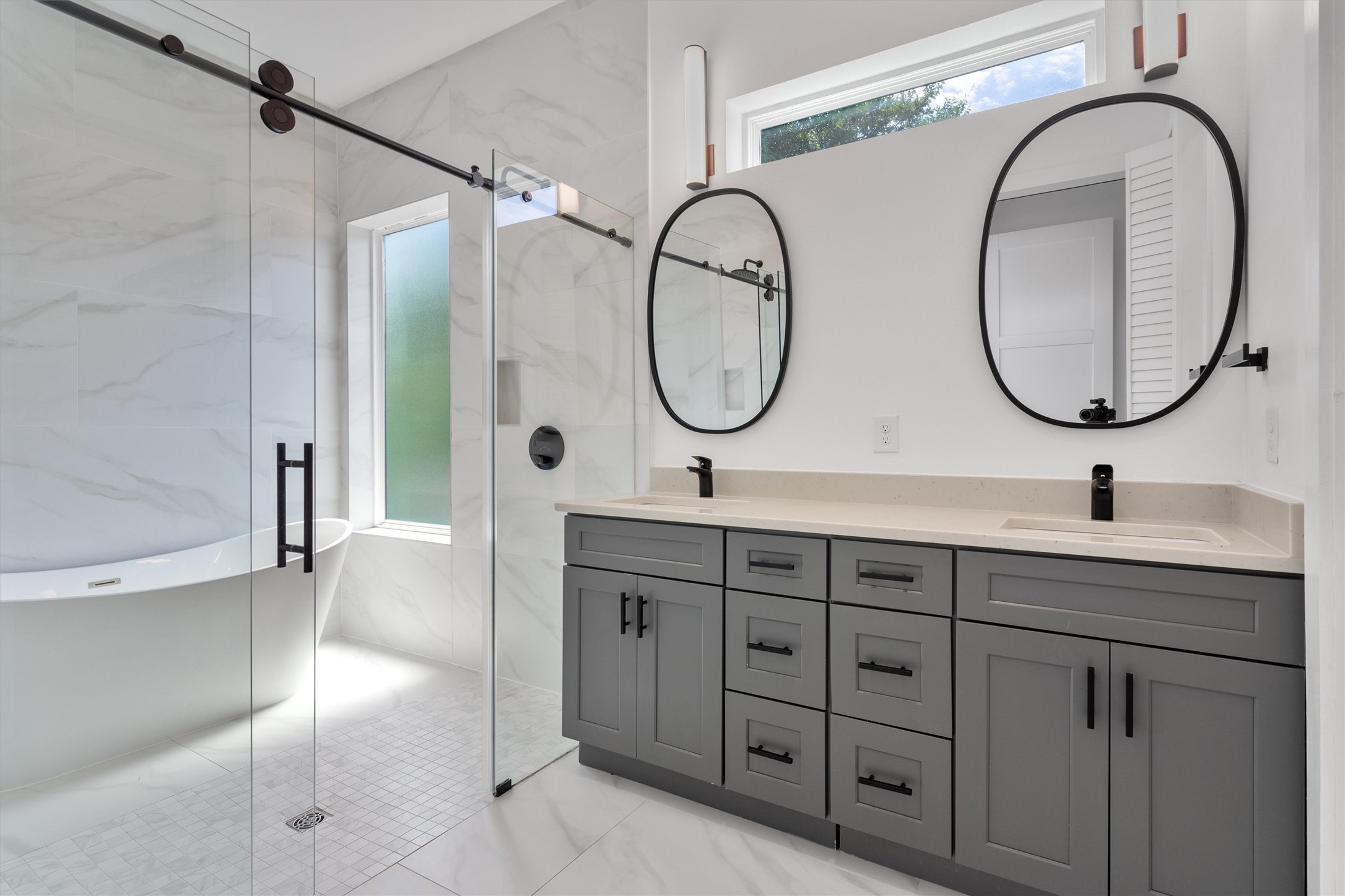 4712 Reyes Street, Unit 1 Austin, TX 78721 - Photo 23 of 38 a bathroom with a double vanity sink and a mirror