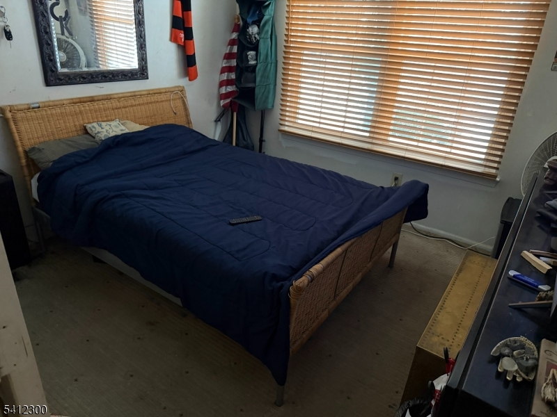 920 Plymouth Road North Brunswick, NJ 08902 - Photo 11 of 13 a bed sitting in a bedroom next to a window