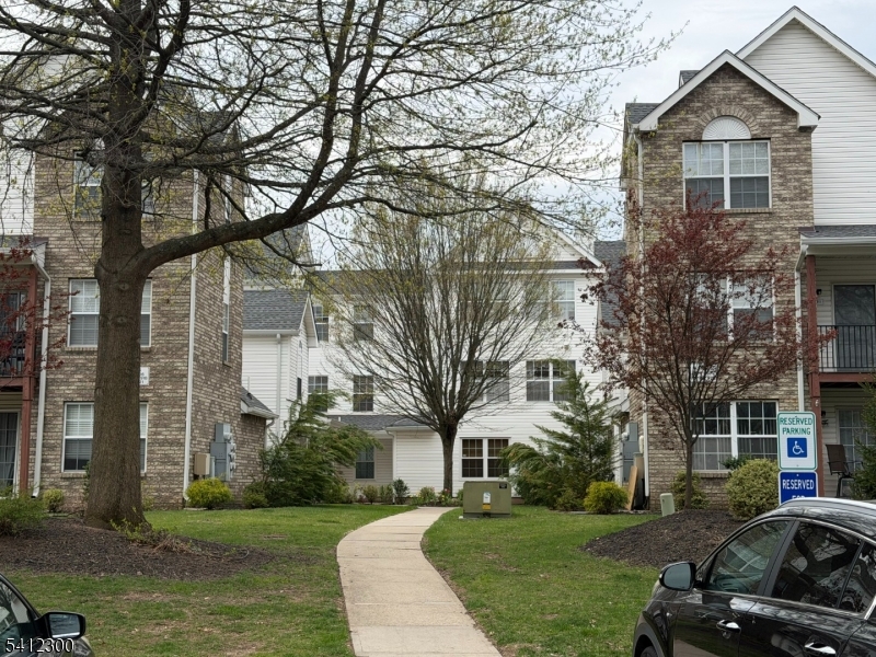 920 Plymouth Road North Brunswick, NJ 08902 - Photo 2 of 17 a view of a white house next to a yard with a yard and large trees