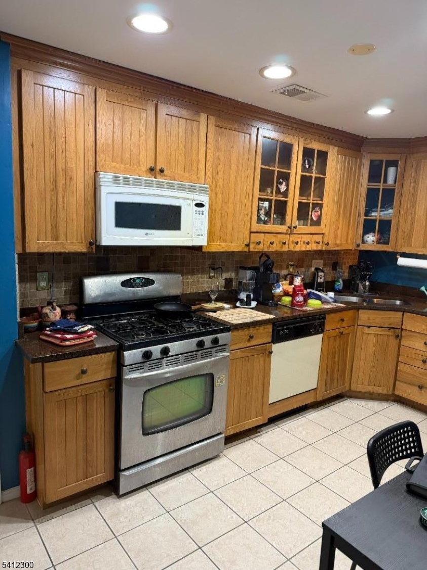 920 Plymouth Road North Brunswick, NJ 08902 - Photo 5 of 17 a kitchen with stainless steel appliances granite countertop a stove a sink and a microwave