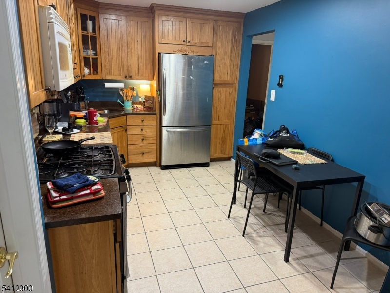 920 Plymouth Road North Brunswick, NJ 08902 - Photo 8 of 17 a kitchen with stainless steel appliances granite countertop a refrigerator and a stove top oven