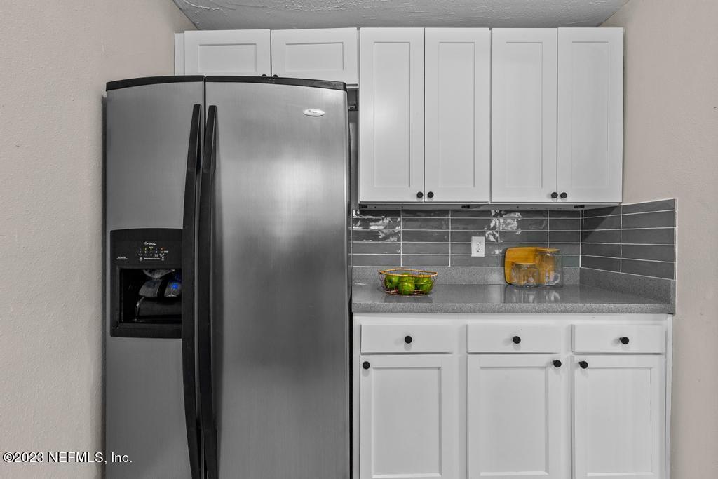 2142 Benedict Road Jacksonville, FL 32209 - Photo 14 of 34 a kitchen with stainless steel appliances a refrigerator and a cabinets