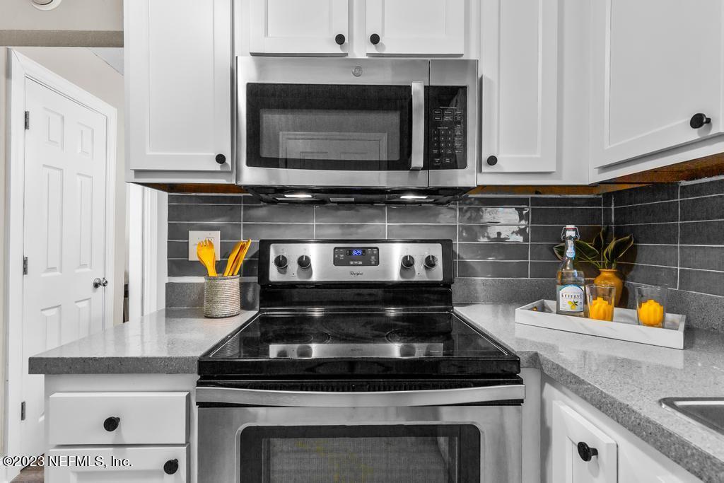 2142 Benedict Road Jacksonville, FL 32209 - Photo 15 of 34 a stove top oven sitting inside of a kitchen