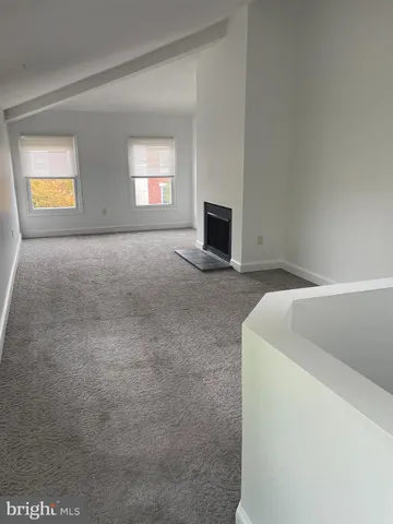 a view of empty room with a fireplace