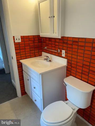 a bathroom with a sink a toilet and mirror