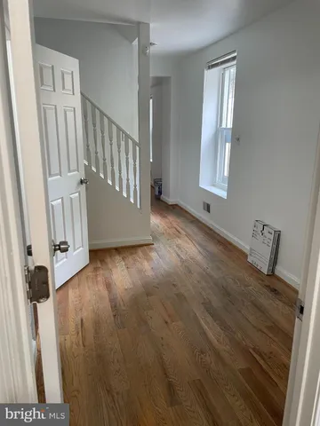 a view of an entryway with wooden floor